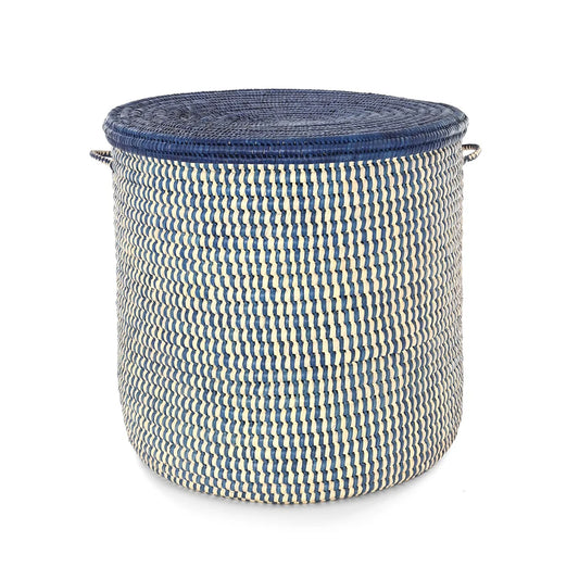 A round woven storage basket with a navy blue lid and side handles, featuring a blue and cream zigzag woven pattern on the body, set against a plain white background.