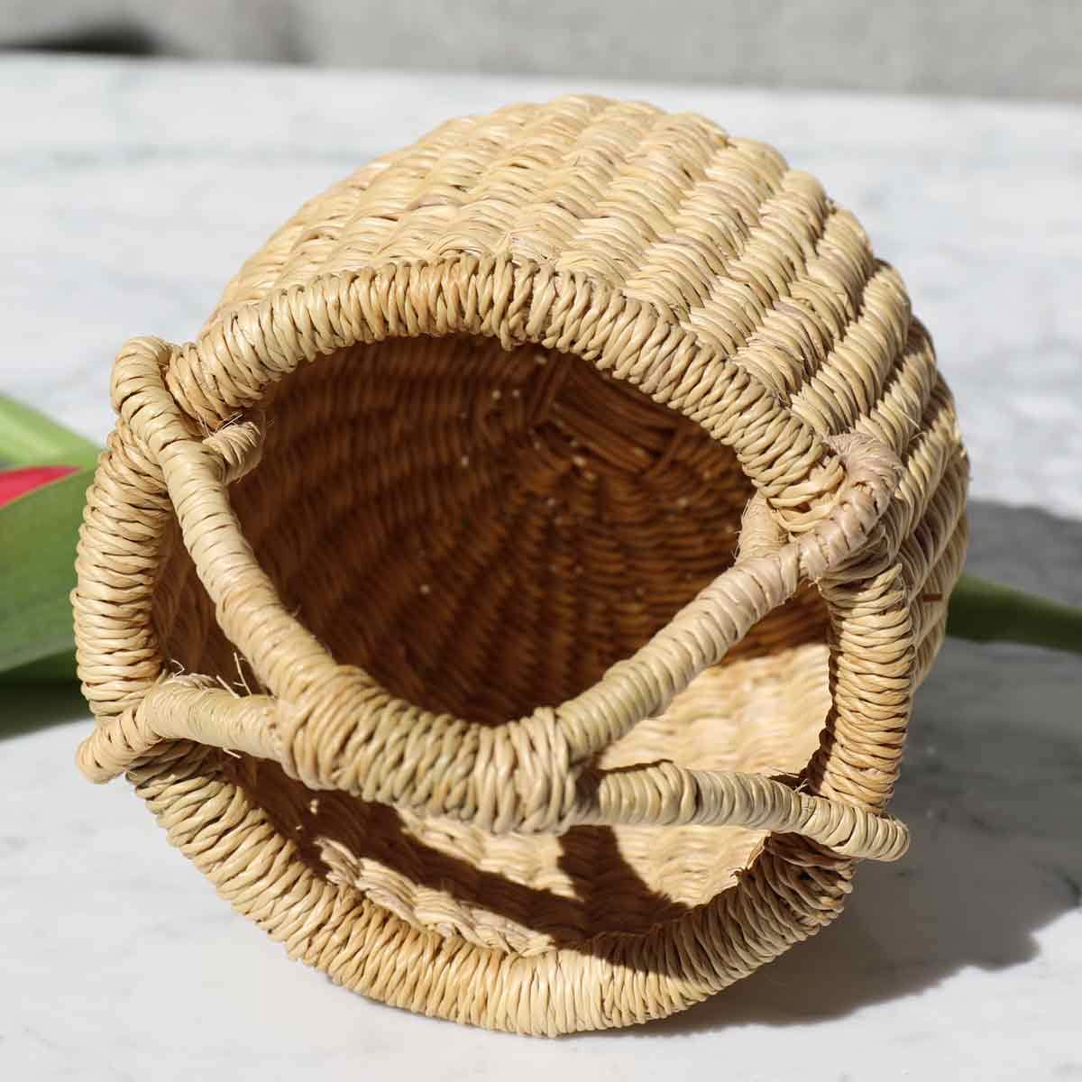 Woven straw basket on a light background
