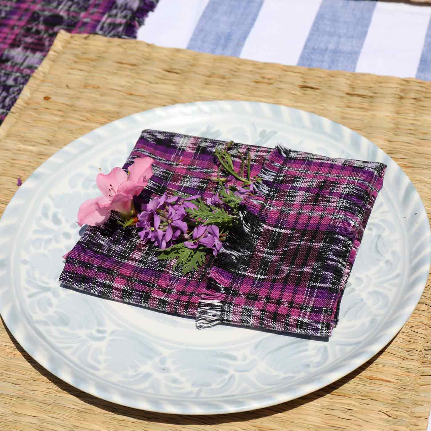 Plaid fabric with flowers on a white plate on a wooden surface